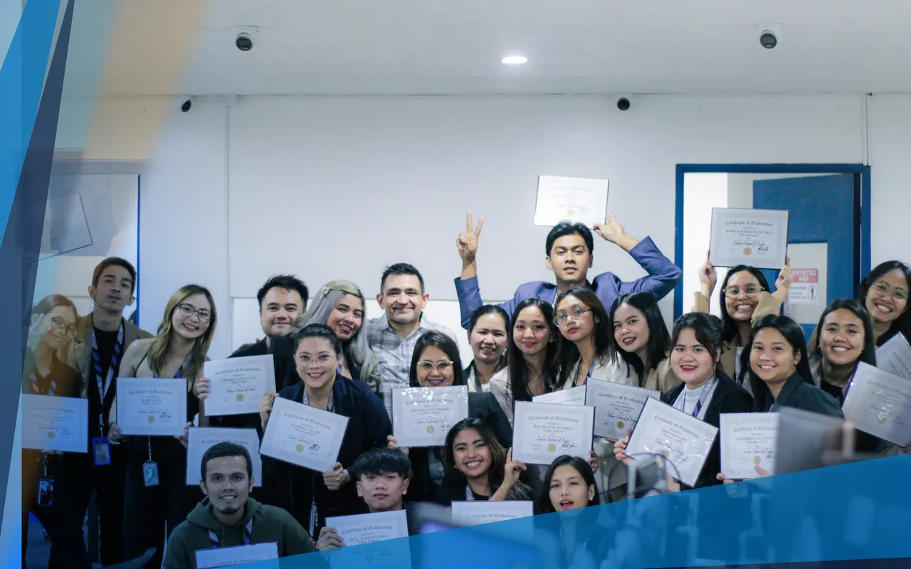 A large group of team members holding up their training certificates